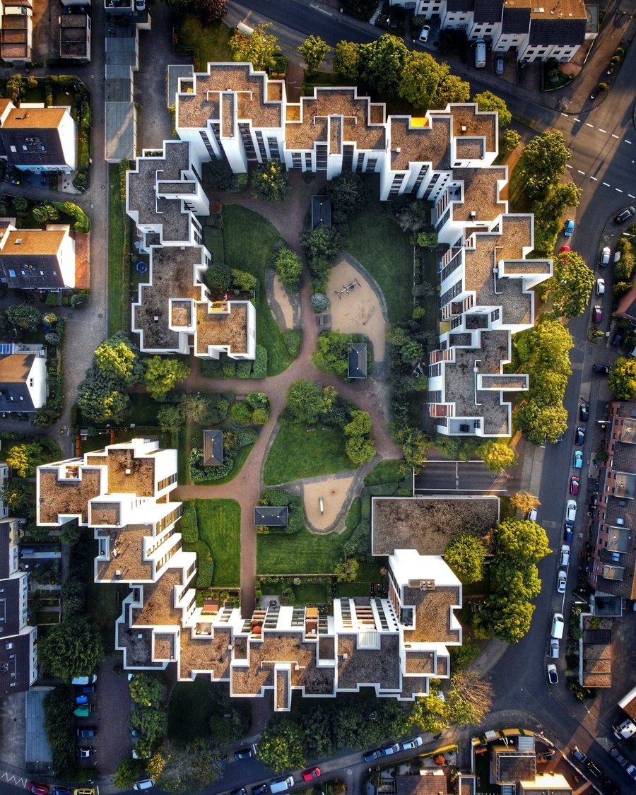 Aerial view of apartment buildings around a landscaped courtyard